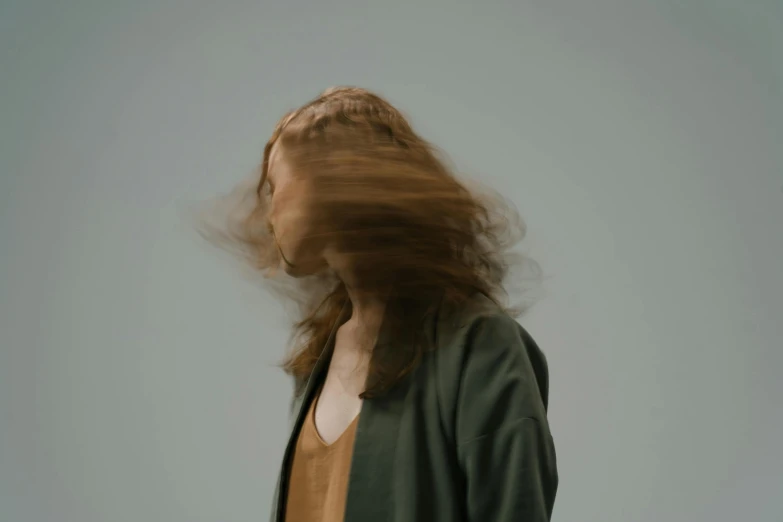 blurry image of woman in a brown shirt