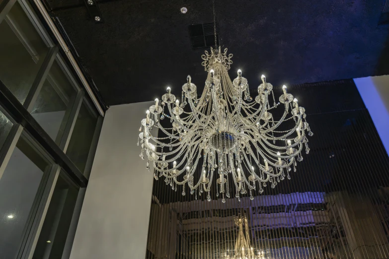 a very pretty crystal chandelier in a big room