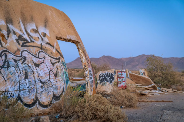 graffiti spray painted on a rusty cement wall