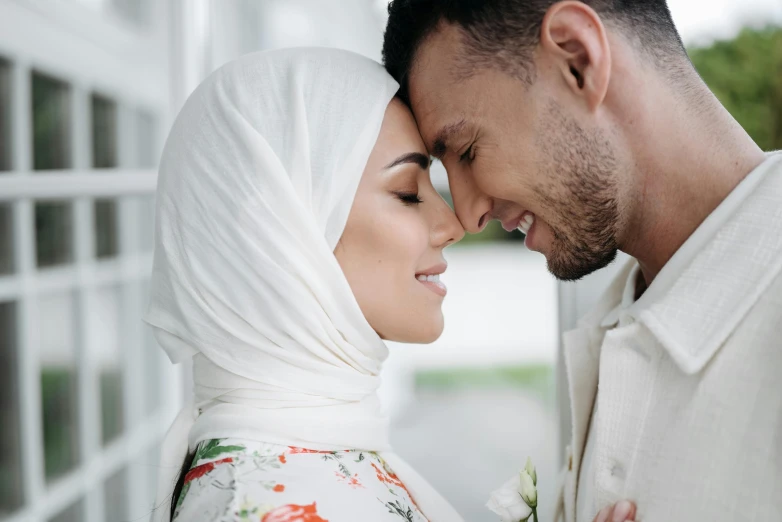 a man and a woman with heads wrapped in white clothing