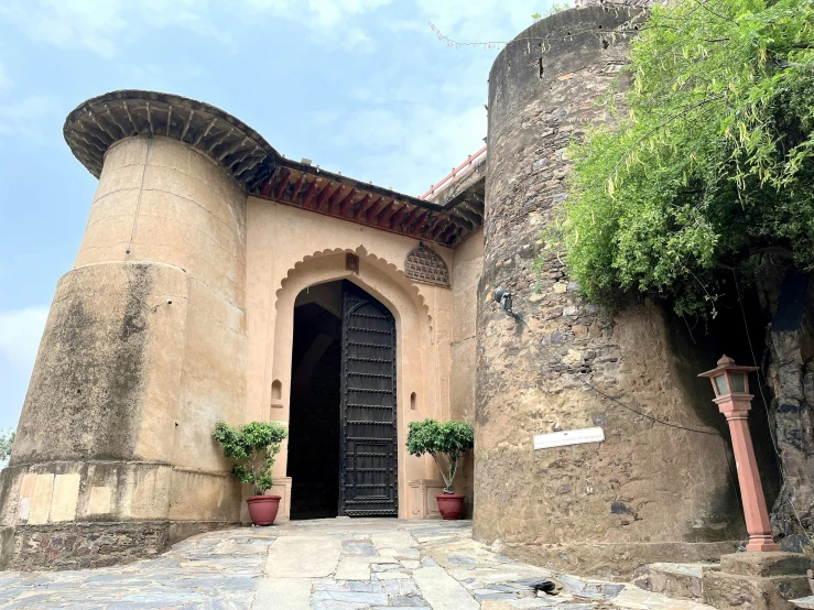 a very tall tower sitting next to a wooden door