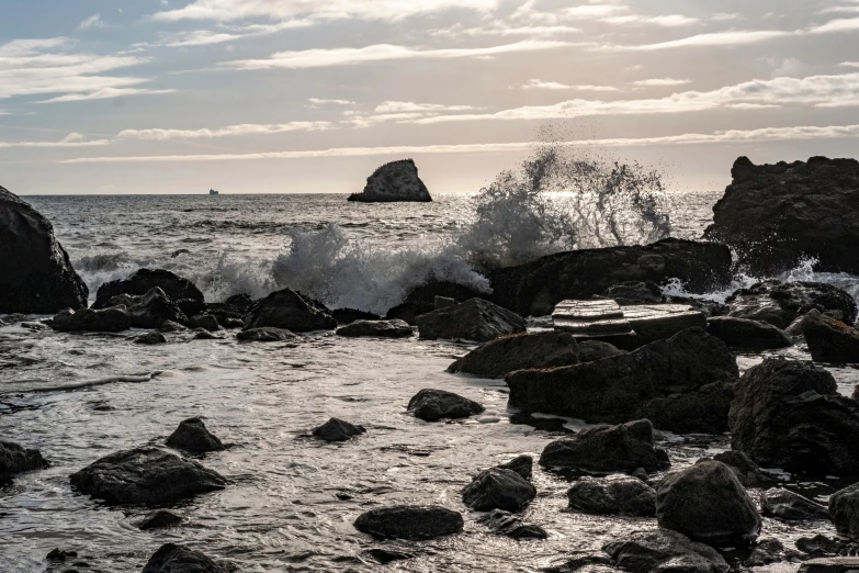 a rocky beach near the ocean and a rock island