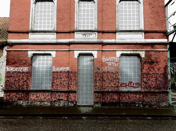 an old building with peeling paint, and closed doors