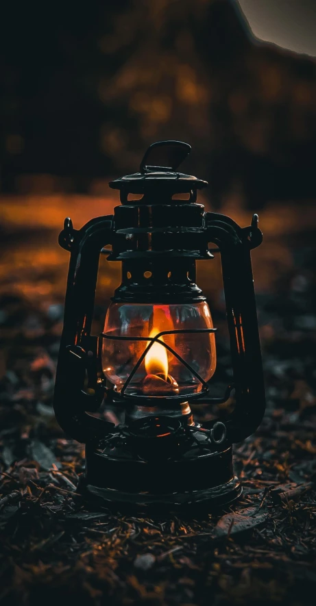 a lantern on the ground burning on it