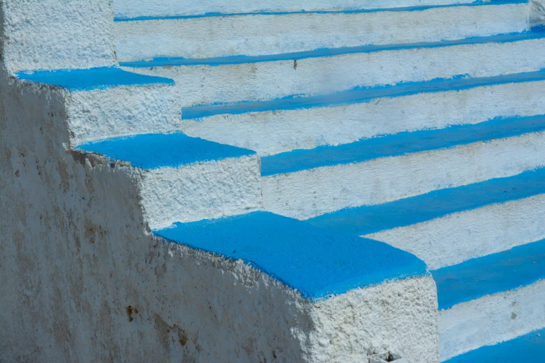 blue painted steps with white painted walls on it