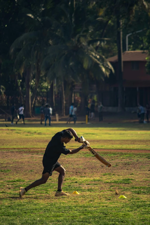 the man is practicing his batting ss in the field