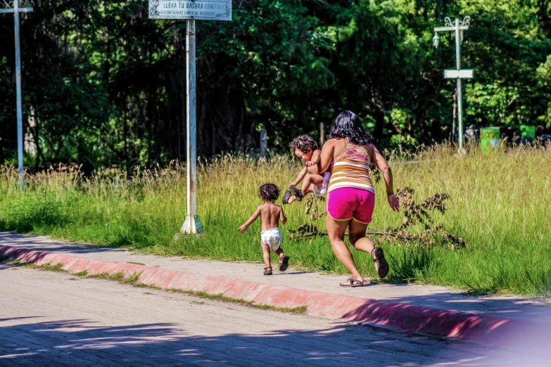 a woman and her child are walking down the street