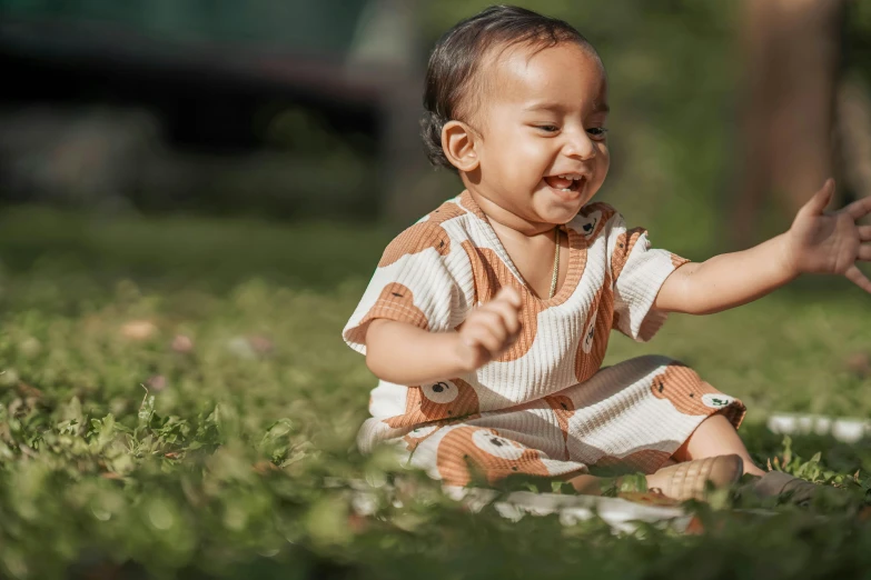 the little child is playing in the grass