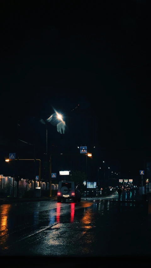 cars on the street at night, in the rain