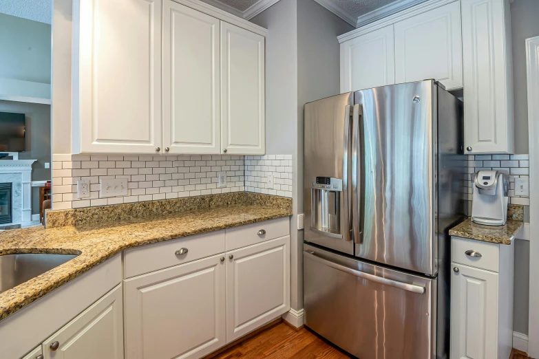 kitchen with stainless steel refrigerator and granite countertops