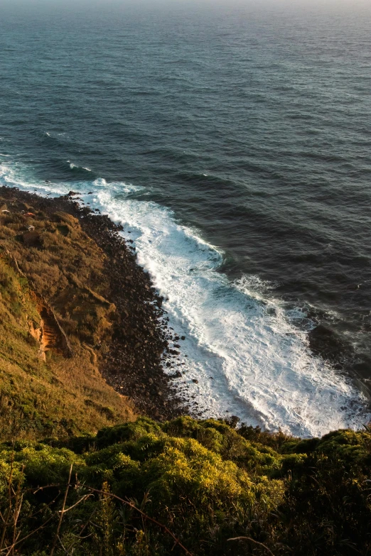 view from the top of a hill overlooking the ocean and cliffs