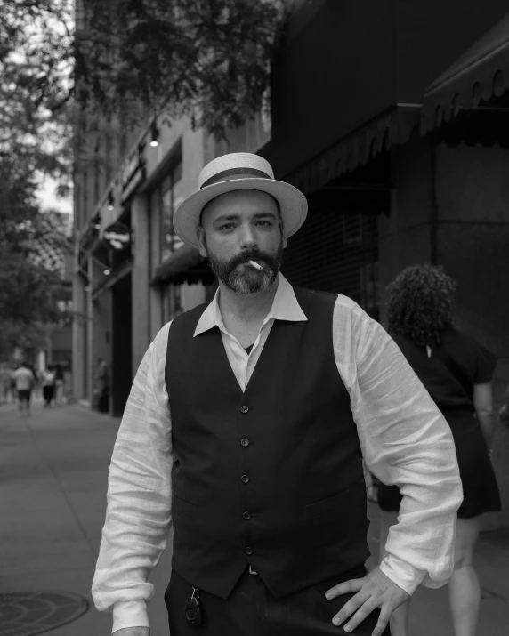 a man in a hat is posing for a picture