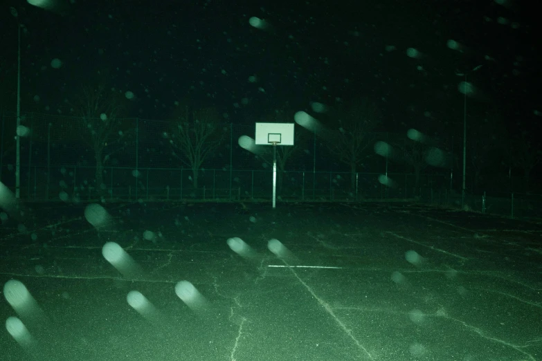 an image of a basketball court at night