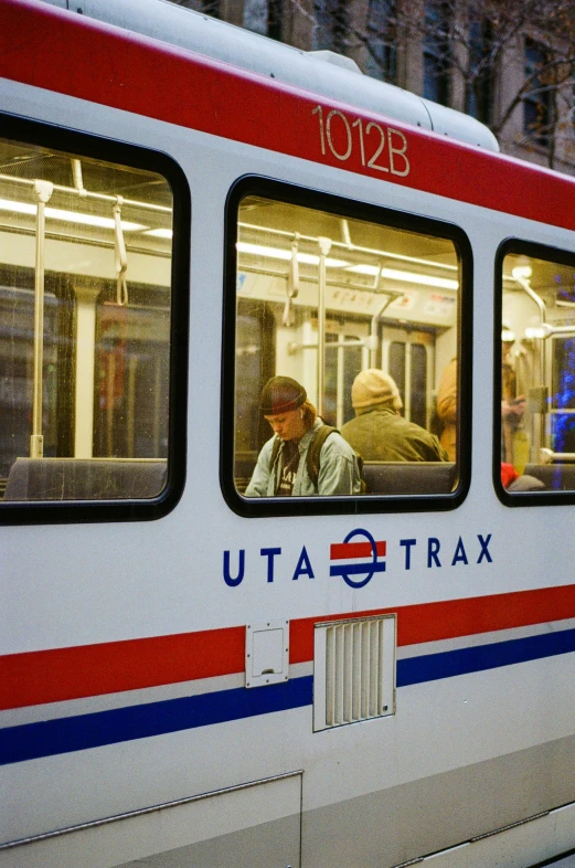 people are looking out of windows on the subway