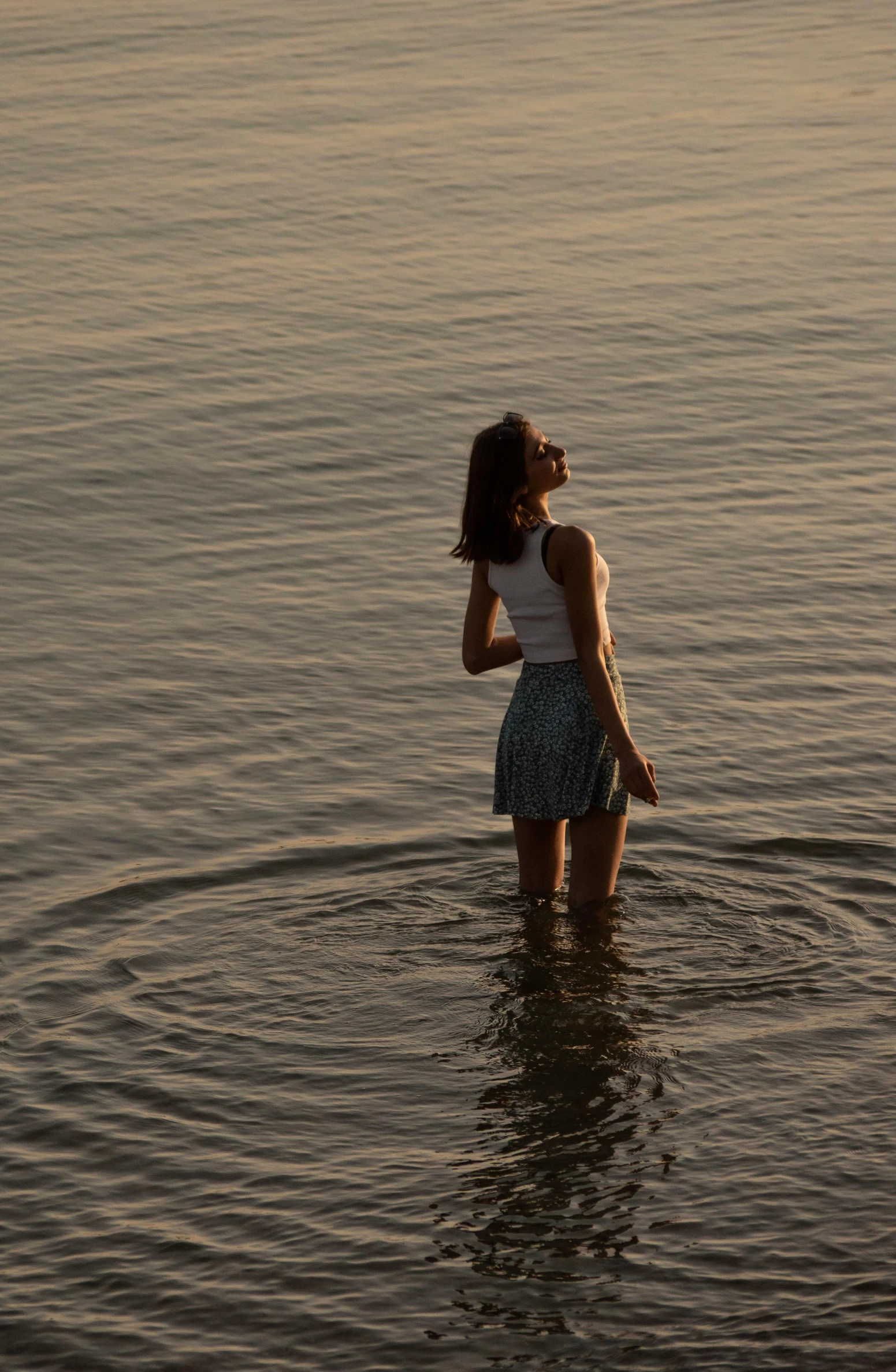 the woman in the picture is standing in water