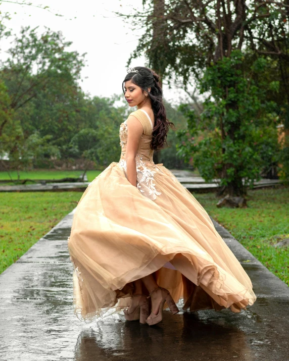 a beautiful young lady in an elegant dress walking in the rain