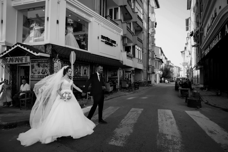 this wedding po shows the bride and groom walking along the streets of town