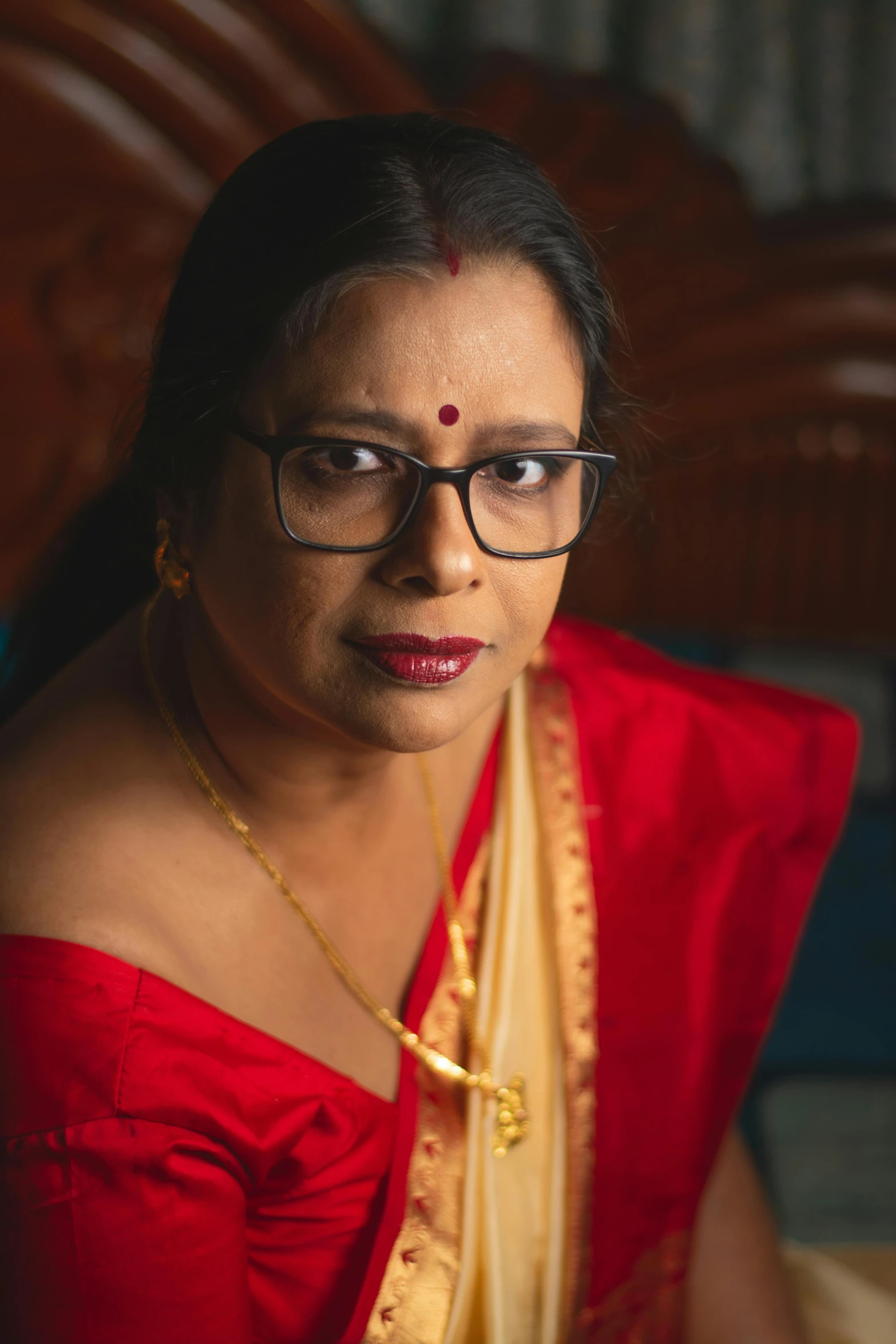 a beautiful woman wearing glasses wearing a scarf