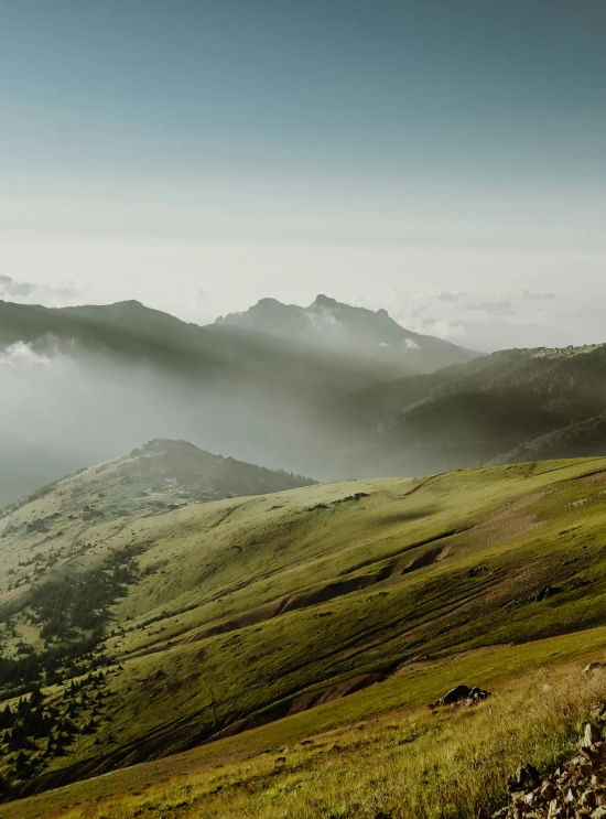 misty fog over mountains and a path