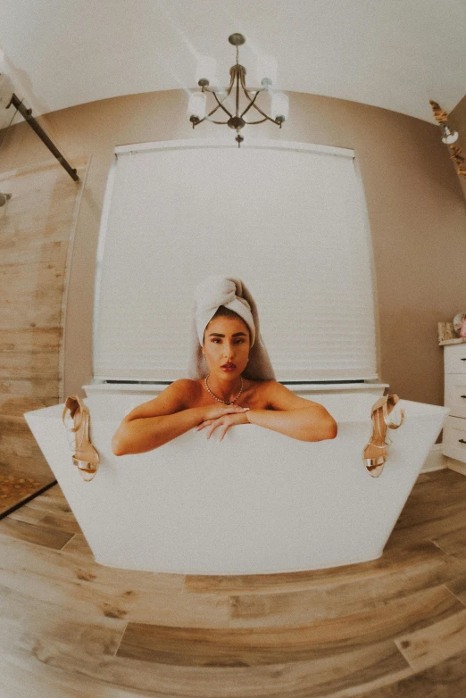 a woman lying in a  tub wearing a headband