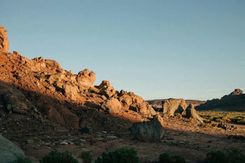 several large rocks sitting on top of a dirt hillside