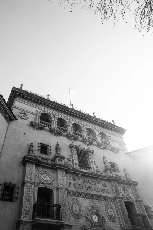 a tall building with windows and some clocks