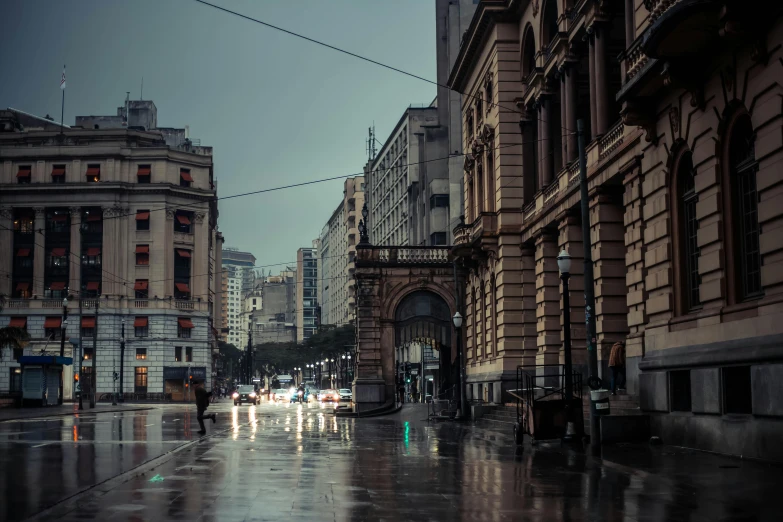 an image of people walking down the street on a rainy day