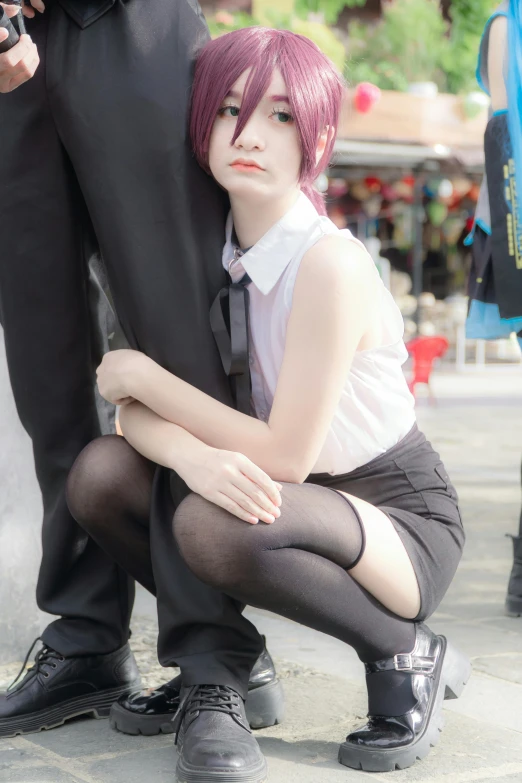 a woman with pink hair kneeling in front of a policeman