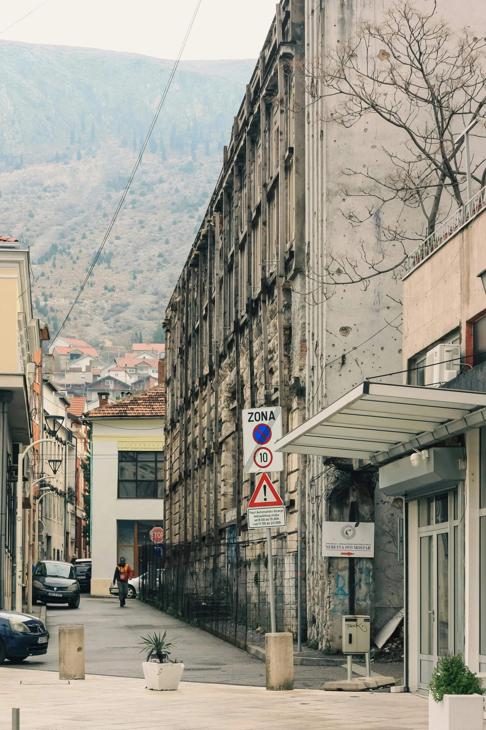 cars on the street below buildings with no parking signs