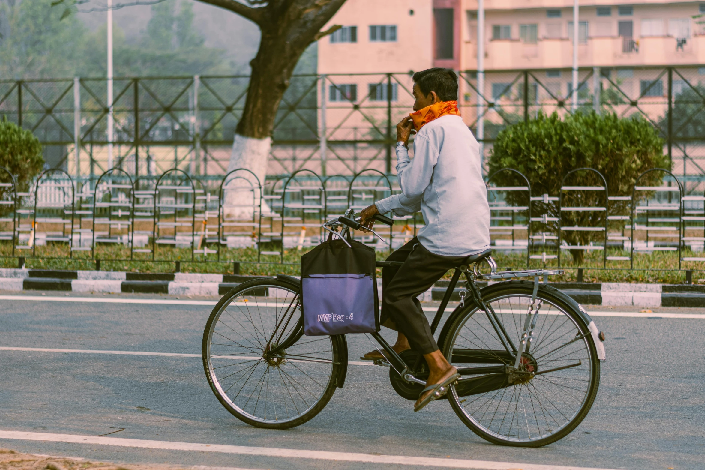 a man riding a bike in front of a street