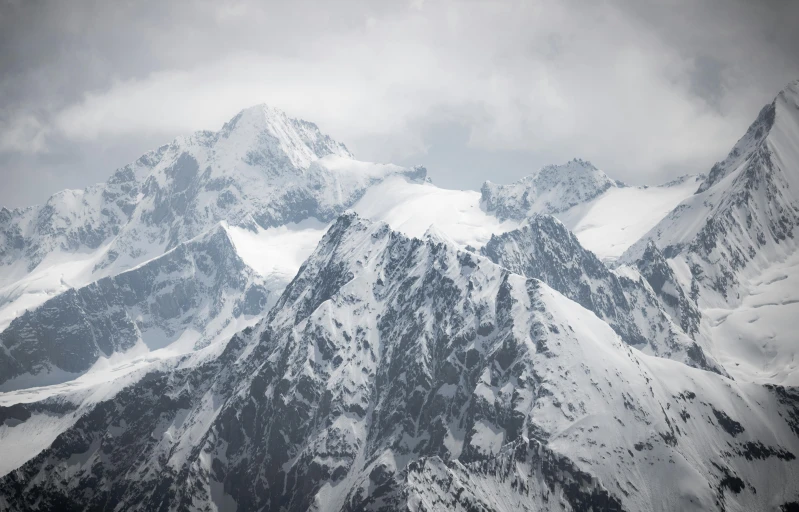 the view of a mountain range covered in snow