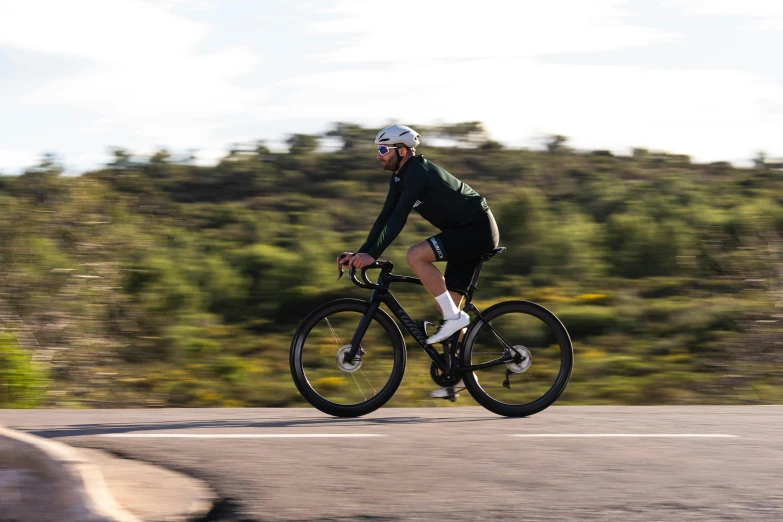 a person riding a bike with trees in the background