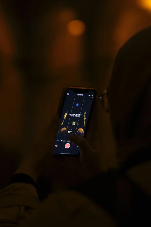 a person that is looking at their cellphone in the dark