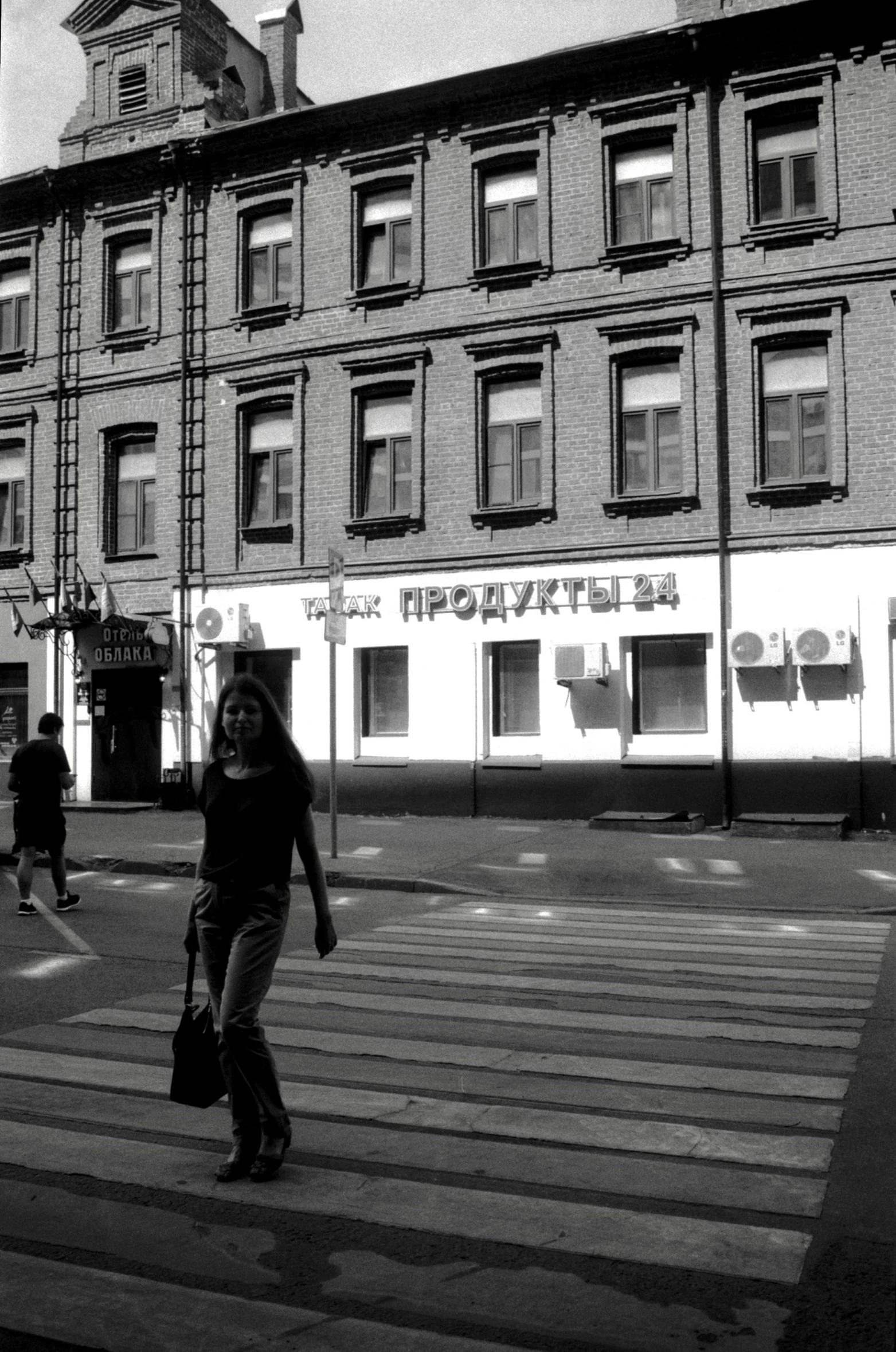 a group of people walking across a street