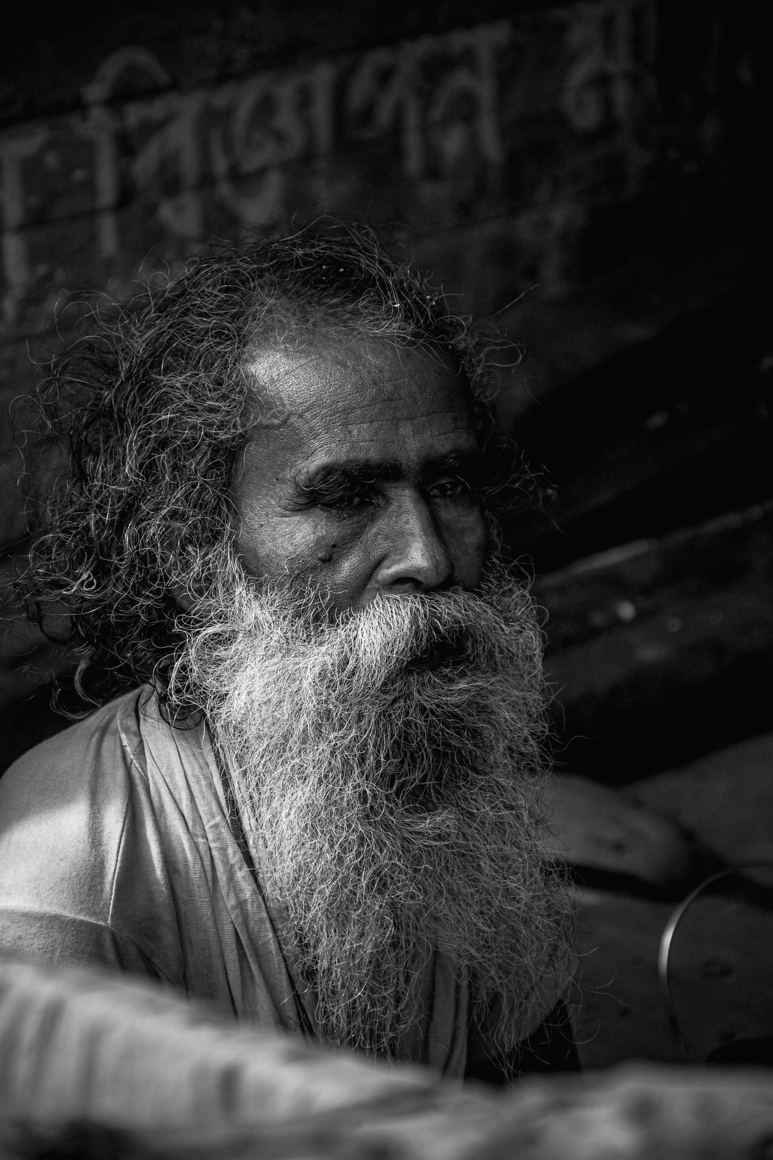 a close - up of a bearded man sitting in bed