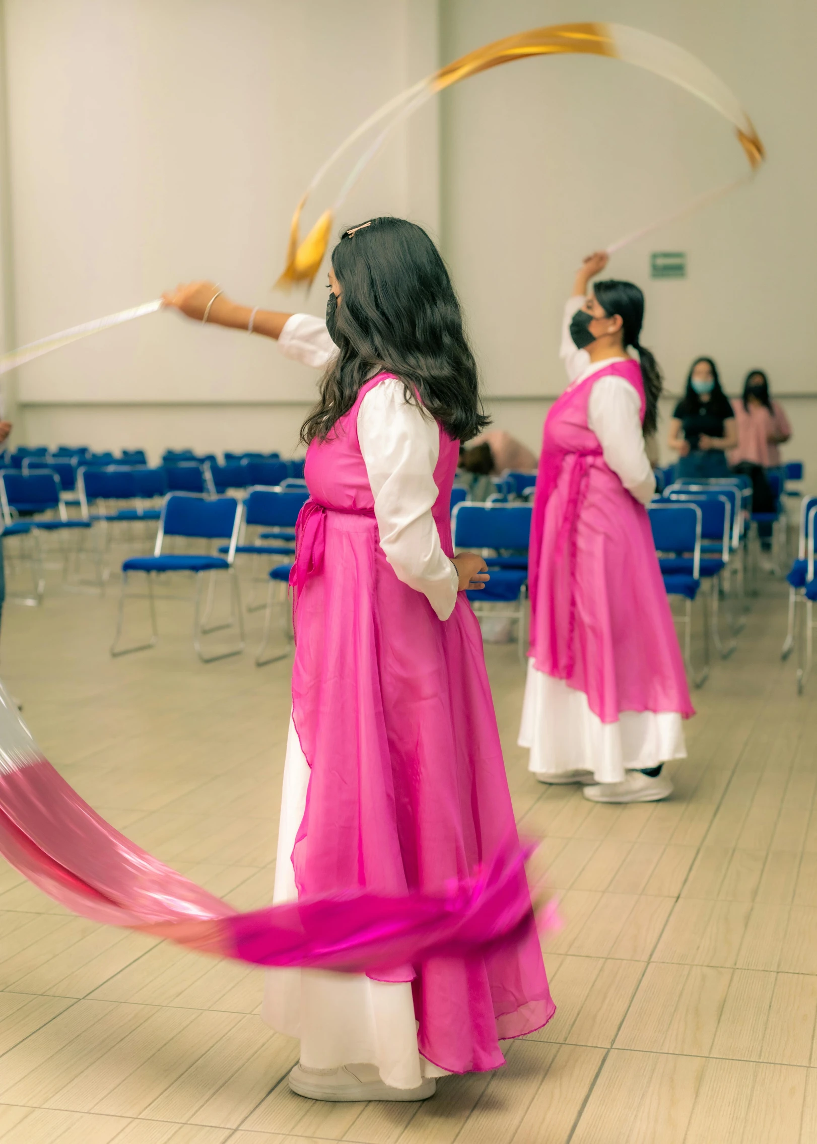 three young women in long skirts performing soing