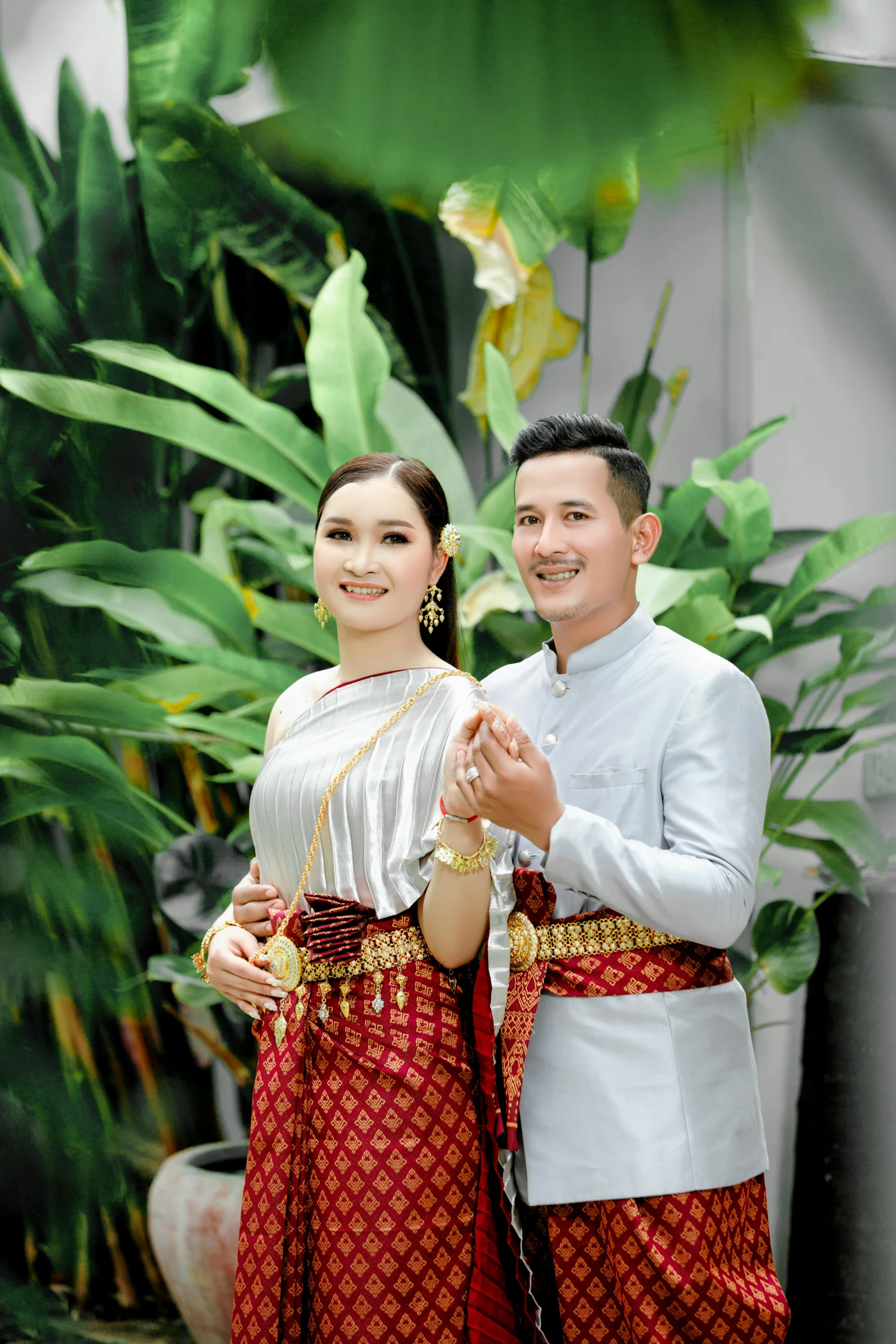 a couple dressed in traditional dress standing beside each other