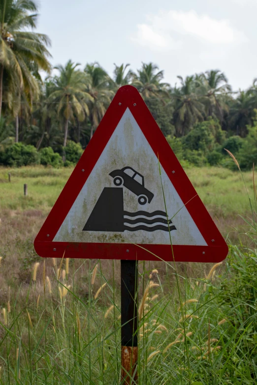 a triangle sign depicting the construction work of a large waterfall