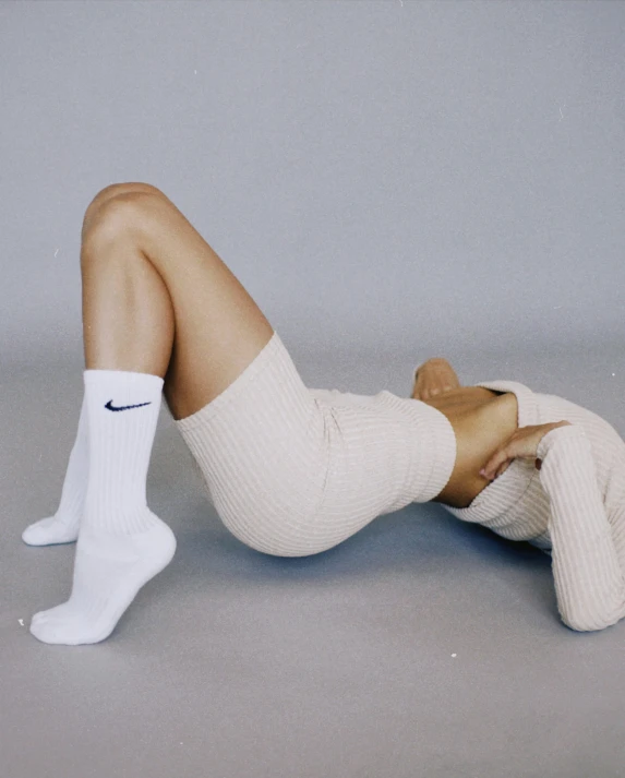 a woman sitting on the floor wearing socks