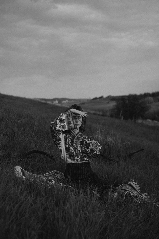 a man that is sitting down in the grass