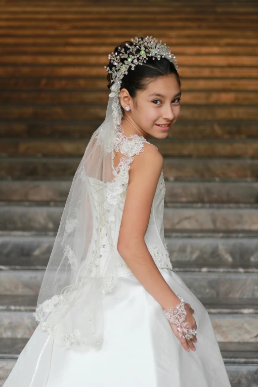 a girl smiles as she stands on some stairs