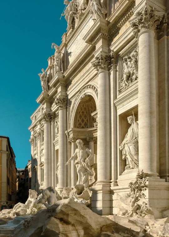 a large building with statues in it on the side