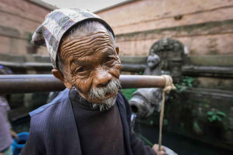 an old man with a hat on walking