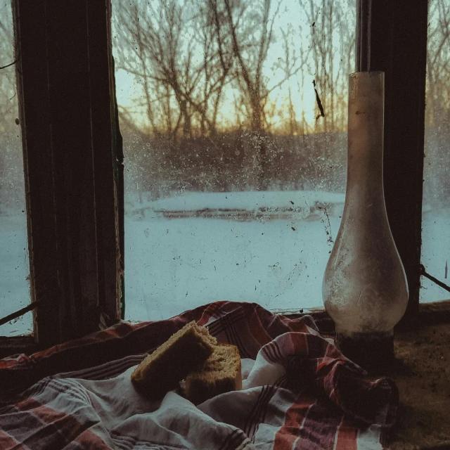a window that has a snow outside and an object next to it