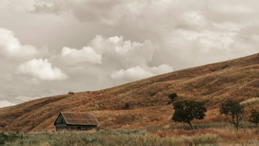 a house on a hill with brown grass