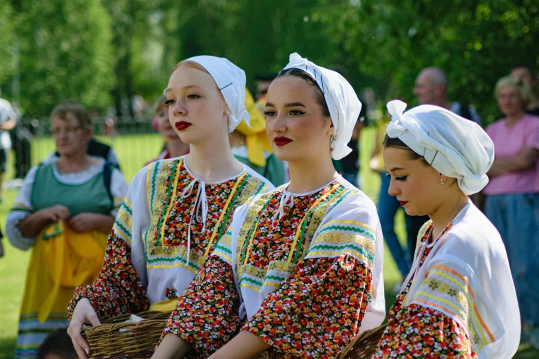 several women wearing white dresses are walking outside