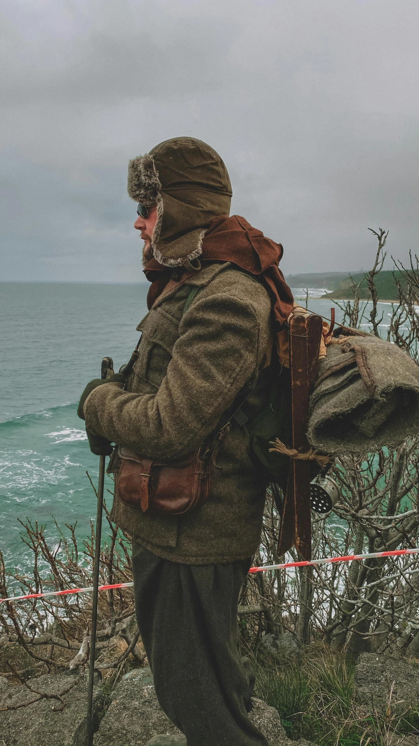 a man on the side of a mountain wearing backpack