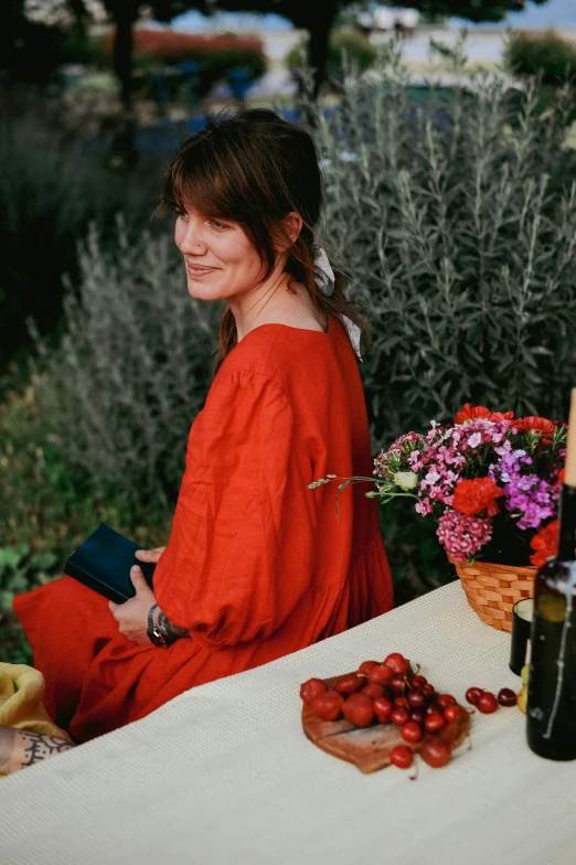 a woman sitting on the ground smiling