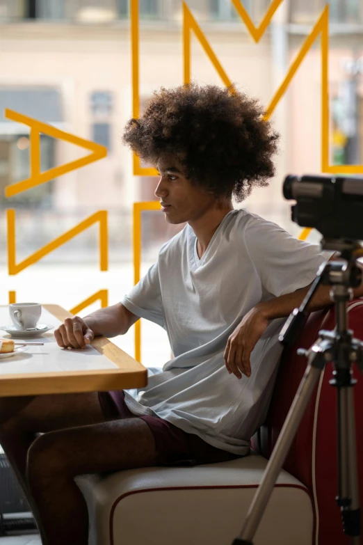 a man that is sitting at a table