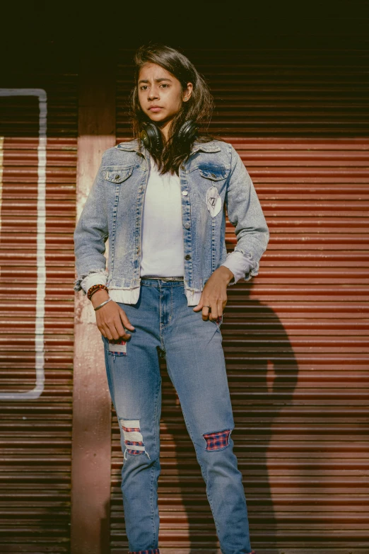 an image of a woman wearing jeans standing next to roller doors